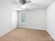 Bedroom featuring neutral carpet, a ceiling fan, and a window at 2618 Mt Holly Huntersville Rd, Charlotte, NC 28214