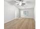 Bright, spacious bedroom with tan carpet, a ceiling fan, and large window at 2618 Mt Holly Huntersville Rd, Charlotte, NC 28214