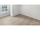 Bedroom featuring neutral carpet and a large window at 2618 Mt Holly Huntersville Rd, Charlotte, NC 28214