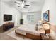 Staged bedroom with neutral walls, carpet, ceiling fan, and large window at 2618 Mt Holly Huntersville Rd, Charlotte, NC 28214