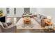 Bright, staged living room with neutral furniture, an area rug, and wood flooring at 2618 Mt Holly Huntersville Rd, Charlotte, NC 28214