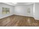 Bright living room featuring hardwood floors and two windows at 2618 Mt Holly Huntersville Rd, Charlotte, NC 28214
