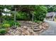 The backyard landscape featuring stone steps, plants, and an overhead trellis at 2951 Evergreen Trl, Vale, NC 28168