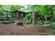 Scenic wooded retreat featuring cozy covered patio and relaxing backyard area at 2951 Evergreen Trl, Vale, NC 28168