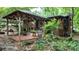 Charming wooded home featuring a cozy covered patio, lush landscaping, and a serene backyard retreat at 2951 Evergreen Trl, Vale, NC 28168
