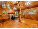 Cozy living room with natural wood paneling, wood floors, and a stone fireplace at 2951 Evergreen Trl, Vale, NC 28168