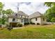 The home features a lovely screened-in sunroom and a backyard with mature trees and lush lawn at 2972 Kaneland Ct, Rock Hill, SC 29732