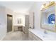 Bright bathroom with dual vanities, walk-in shower, and swan-themed stained glass window above tub at 2972 Kaneland Ct, Rock Hill, SC 29732