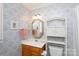 Cozy bathroom features a vanity with a golden mirror, and charming floral wallpaper, creating a welcoming space at 2972 Kaneland Ct, Rock Hill, SC 29732