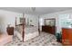 Traditional bedroom with four-poster bed, wooden dressers, and floral carpeting at 2972 Kaneland Ct, Rock Hill, SC 29732