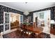 Formal dining room boasts distinctive wallpaper, hardwood table set, and views to living area at 2972 Kaneland Ct, Rock Hill, SC 29732