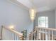Bright foyer with chandelier, white staircase, and window overlooking front door at 2972 Kaneland Ct, Rock Hill, SC 29732
