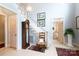 Inviting foyer featuring hardwood floors, a classic grandfather clock, and staircase with white wooden railing at 2972 Kaneland Ct, Rock Hill, SC 29732