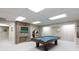 Spacious game room featuring a pool table, brick fireplace, and retro jukebox offers entertainment and relaxation at 2972 Kaneland Ct, Rock Hill, SC 29732