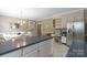 Open kitchen with breakfast bar, white cabinets, stainless refrigerator, and adjacent breakfast nook at 2972 Kaneland Ct, Rock Hill, SC 29732