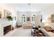 Spacious living room featuring large windows, a brick fireplace, and plush seating at 2972 Kaneland Ct, Rock Hill, SC 29732