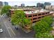 Aerial view of brick apartment building surrounded by lush green trees and busy streets at 310 Arlington Ave # 409, Charlotte, NC 28203