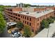 Aerial view of brick apartment building with a flat roof and cars parked out front at 310 Arlington Ave # 409, Charlotte, NC 28203