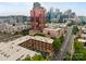 An aerial view of an area with various buildings, trees, and busy streets at 310 Arlington Ave # 409, Charlotte, NC 28203