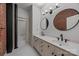 Bathroom featuring double sinks, tile flooring, and modern fixtures at 310 Arlington Ave # 409, Charlotte, NC 28203