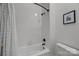 Bathroom featuring tiled shower with a white shower curtain and bronze fixtures at 310 Arlington Ave # 409, Charlotte, NC 28203
