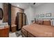 Bedroom with exposed brick accent wall, neutral colors, and vintage furniture at 310 Arlington Ave # 409, Charlotte, NC 28203