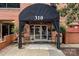 Exterior building entrance featuring a black awning with the address 310 at 310 Arlington Ave # 409, Charlotte, NC 28203