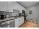 Well-equipped kitchen with white cabinetry, granite countertops, and stainless steel appliances at 310 Arlington Ave # 409, Charlotte, NC 28203
