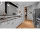 Kitchen featuring white cabinetry, stone countertops, and access to dining and living areas at 310 Arlington Ave # 409, Charlotte, NC 28203