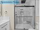 Shower boasting frameless glass enclosure with marble tiling and matte black fixtures at 317 N Cemetery St, Richfield, NC 28137