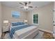 A bedroom is virtually staged with blue bedding and beach wall art at 317 N Cemetery St, Richfield, NC 28137