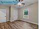 A bedroom features wood-look flooring, a ceiling fan, a window that offers plenty of natural light, and white doors at 317 N Cemetery St, Richfield, NC 28137