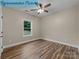 Bedroom showcasing wood-look flooring, a ceiling fan, and a bright window with lots of natural light at 317 N Cemetery St, Richfield, NC 28137