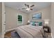 This staged bedroom boasts wood-look flooring, a ceiling fan, and a bright window that offers lots of natural light at 317 N Cemetery St, Richfield, NC 28137