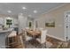 Dining room with a wooden table set for six, complemented by modern decor and a view to the backyard at 317 N Cemetery St, Richfield, NC 28137