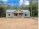 Eye-catching exterior of home featuring a cozy front porch, windows, and well-manicured lawn at 317 N Cemetery St, Richfield, NC 28137