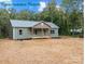 Inviting exterior of home, showcasing front porch and complemented by natural surroundings at 317 N Cemetery St, Richfield, NC 28137