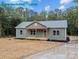 A charming exterior view of a one-story home with green siding at 317 N Cemetery St, Richfield, NC 28137