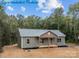 A charming exterior view of a one-story home with green siding at 317 N Cemetery St, Richfield, NC 28137