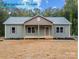 Charming exterior of home featuring a cozy front porch and well-manicured lawn at 317 N Cemetery St, Richfield, NC 28137