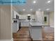 Modern kitchen boasts white cabinetry, granite countertops, stainless steel appliances, and a center island at 317 N Cemetery St, Richfield, NC 28137