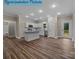 Open-concept kitchen features white cabinets, granite counters, and stainless steel appliances, flowing into a dining area at 317 N Cemetery St, Richfield, NC 28137