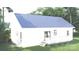 Rear exterior view showcasing a white home with a walkout deck and simple landscaping at 317 N Cemetery St, Richfield, NC 28137