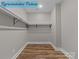 A large walk-in closet featuring modern wood-look flooring and white shelving at 317 N Cemetery St, Richfield, NC 28137