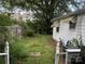 Backyard view showcasing ample space and mature trees; the fence line adds privacy at 3500 Blessing St, Charlotte, NC 28208