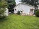 Backyard showcasing a storage shed, a grassy lawn, and the home's exterior at 3500 Blessing St, Charlotte, NC 28208