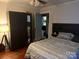 Cozy bedroom with modern decor featuring a bed with patterned linens and a storage cabinet at 3500 Blessing St, Charlotte, NC 28208