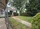 Front yard view with walkway leading to the entrance, featuring a carport at 3500 Blessing St, Charlotte, NC 28208