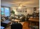 Comfortable living room featuring hardwood floors, sofa, and unique decor displayed around the space at 3500 Blessing St, Charlotte, NC 28208