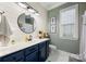 Bright bathroom featuring a blue vanity, large round mirror, and modern fixtures at 362 Windell Dr # 67, Fort Mill, SC 29708